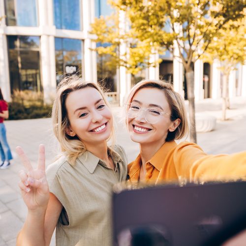 Two friends taking a selfie downtown